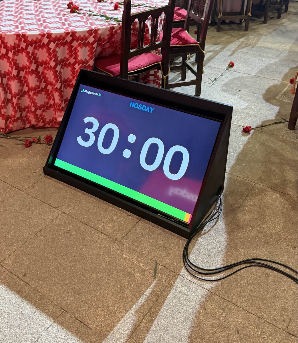 Stagetimer confidence monitor on the floor at a conference dinner in Galicia, Spain, showing 30:00 countdown