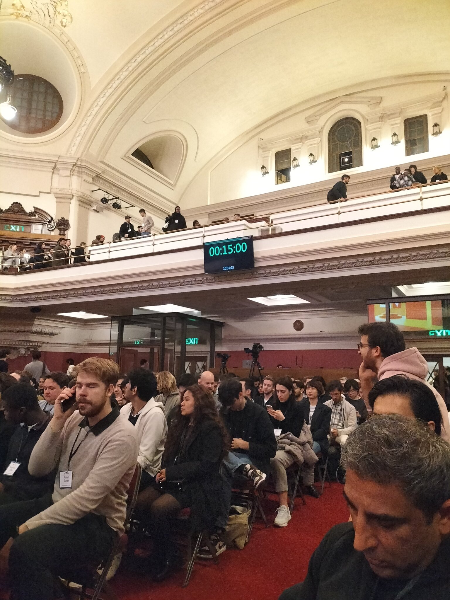 YC Startup School London in a grand ornate hall with Stagetimer countdown showing 15:00 on a display mounted on the balcony