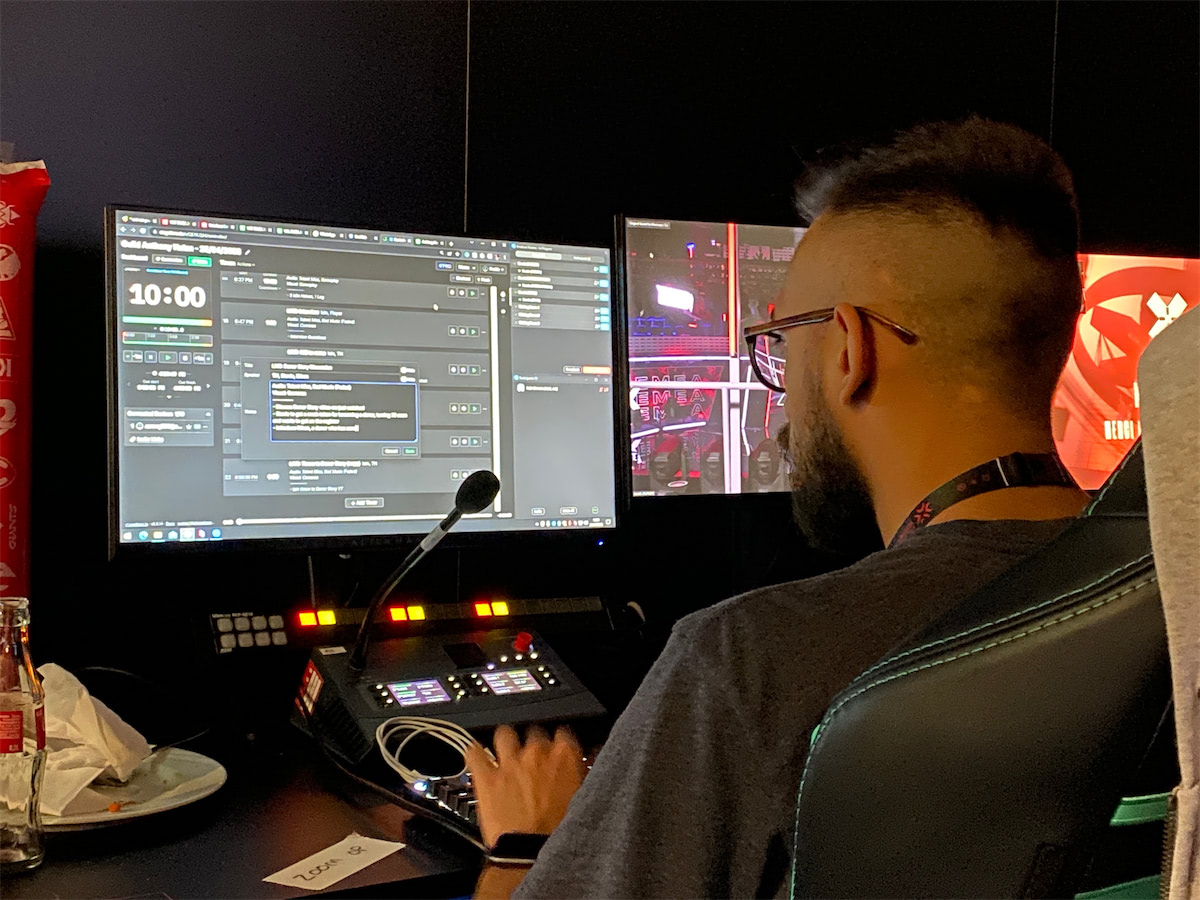 Production team member operating broadcast equipment with Stagetimer visible on control panel during professional esports tournament