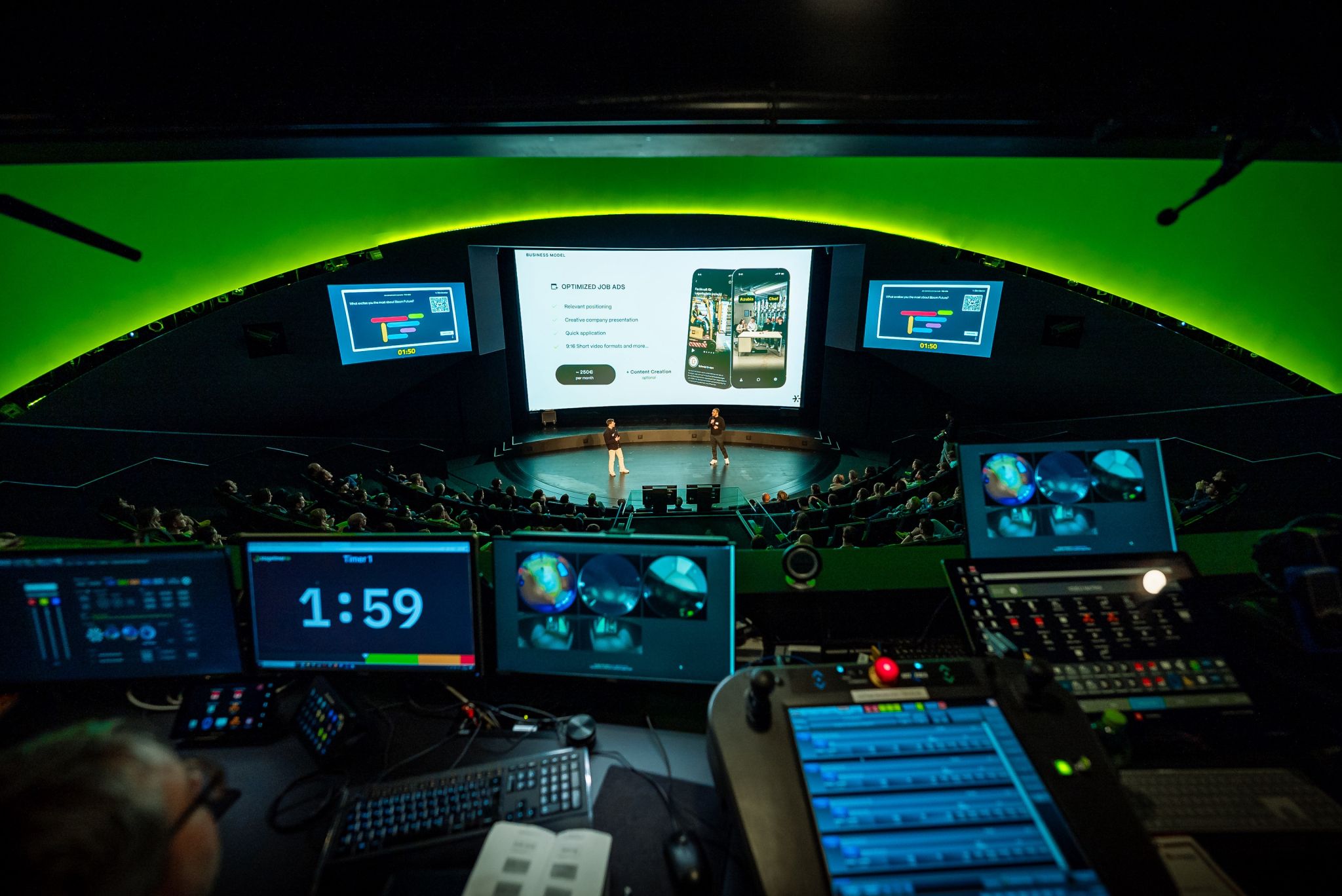 Production control booth overlooking AI Founders Demo Day stage with Stagetimer on monitor