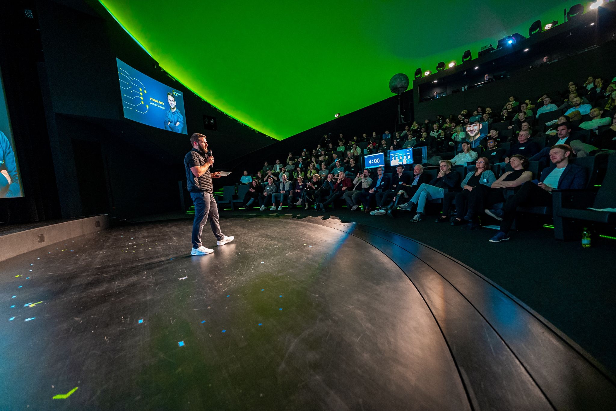 Speaker on stage at AI Founders Demo Day with Stagetimer countdown visible showing 4:00 minutes